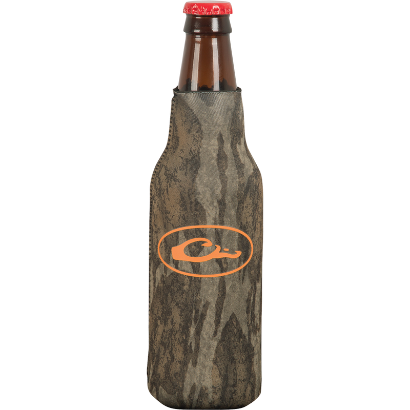 A brown glass bottle with a red cap, featuring an orange logo on a grey surface. The bottle cooler has a side zipper for a snug fit and a separate bottom piece to prevent tipping over.