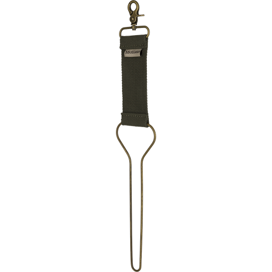 A close-up of the McAlister Game Bird Totes key chain, featuring solid metal hardware and a brass clip.