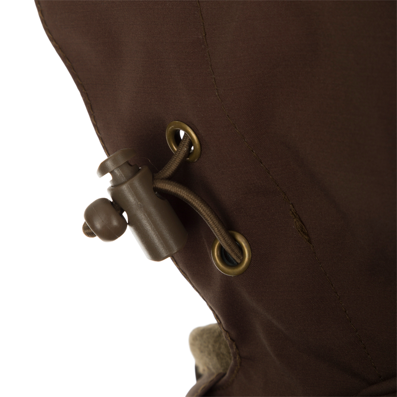 A close-up of the McAlister G3 Flex 3-in-1 Waterfowler's Jacket, featuring a brown fabric with a rope detail.