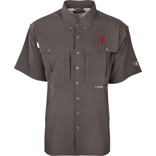 A close-up of the Alabama S/S Flyweight Wingshooter shirt, featuring a logo and red letter. Lightweight and breathable, with moisture-wicking fabric, vented back, and UPF 50+ sun protection. Magnattach™ and zippered pockets included.