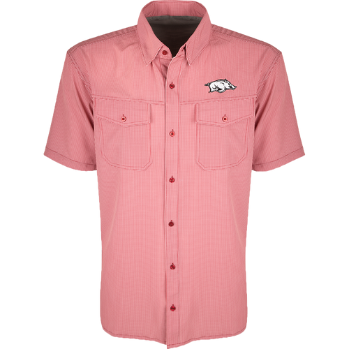 Arkansas S/S Traveler's Shirt, a red and white checkered shirt with a pig on it. Lightweight, breathable fabric with four-way stretch for comfort. Moisture-wicking, wrinkle-resistant construction. Features 2 chest pockets with button flaps. Ideal for early season baseball games or weekend tailgates.