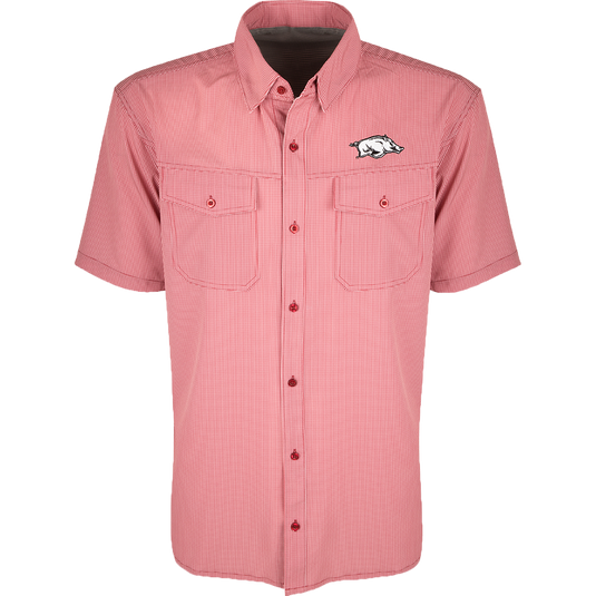 Arkansas S/S Traveler's Shirt, a red and white checkered shirt with a pig on it. Lightweight, breathable fabric with four-way stretch for comfort. Moisture-wicking, wrinkle-resistant construction. Features 2 chest pockets with button flaps. Ideal for early season baseball games or weekend tailgates.