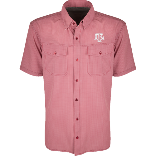 A red and white plaid shirt with four-way stretch for freedom of movement and ultimate comfort. Lightweight and wrinkle resistant, perfect for early season football games or weekend tailgates. Features moisture-wicking fabric and two chest pockets with button flaps. Texas A&M logo embroidered on the left chest.