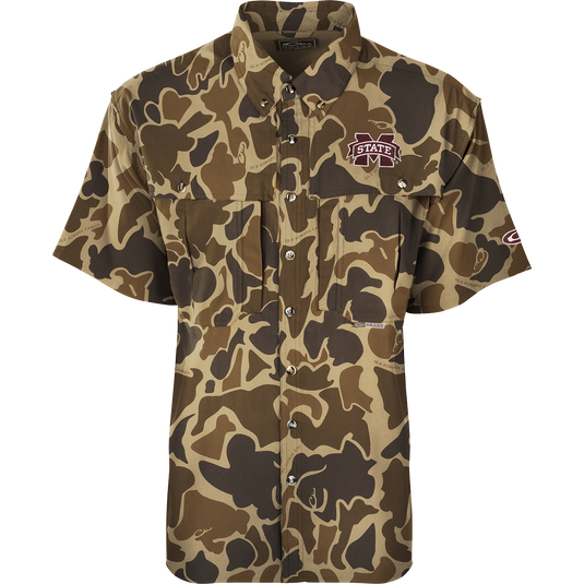 Mississippi State S/S Flyweight Wingshooter: A camouflage shirt with a logo, made of ultra-lightweight polyester. Quick-drying, moisture-wicking, and breathable. Features include vented back, UPF 50+ sun protection, Magnattach™ chest pocket, and a vertical zipper pocket. Ideal for warm-weather outdoor activities.