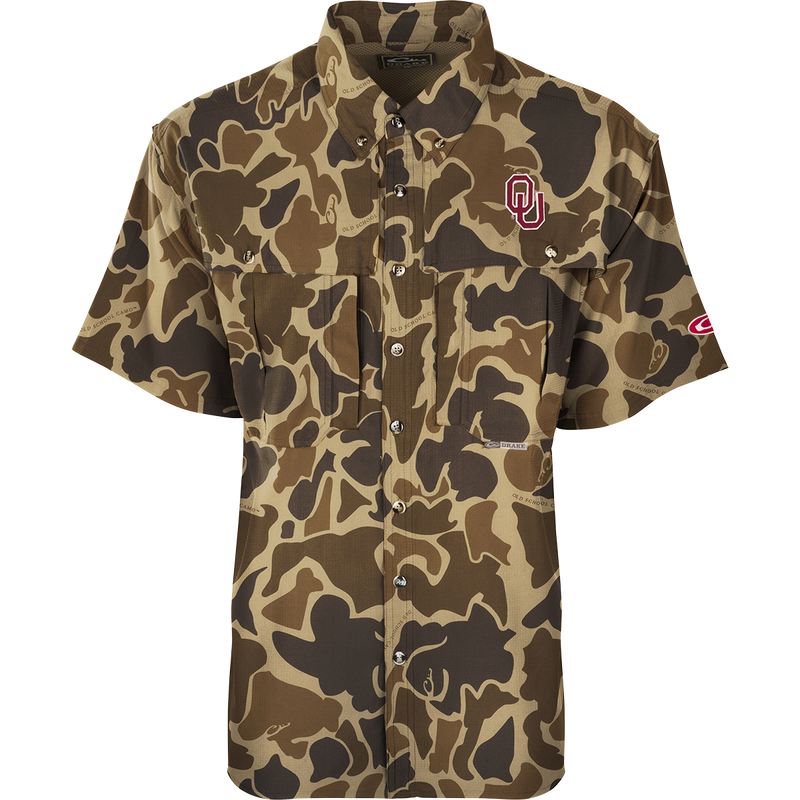 A close-up of the Oklahoma S/S Flyweight Wingshooter shirt with a logo. Lightweight, breathable, and quick-drying polyester fabric. Features include vented back design, UPF 50+ sun protection, chest pockets, and a zippered pocket. Ideal for warm-weather outdoor activities.