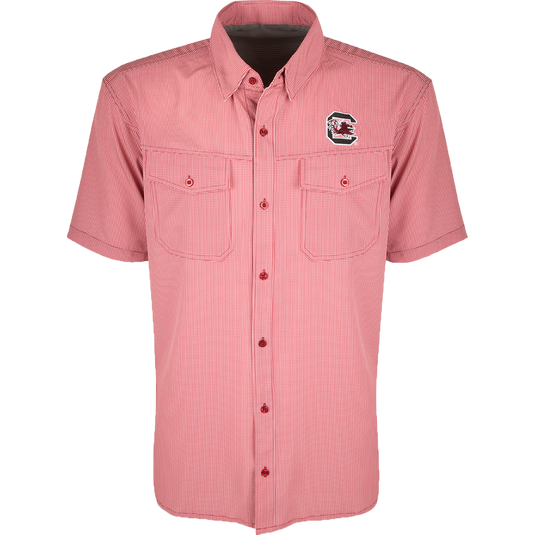 South Carolina S/S Traveler's Shirt - A lightweight, breathable plaid shirt with four-way stretch for freedom of movement. Features moisture-wicking fabric, button flaps on chest pockets, and a South Carolina logo embroidered on the left chest. Ideal for early season football games or weekend tailgates with friends.