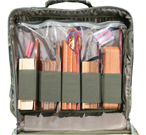 Ol' Tom Treasure Chest, a bag with wood pieces, red and yellow cable, plastic container, hotdog, white object, piece of wood, brown leather case, and grey fabric.