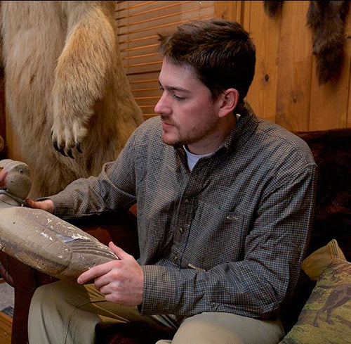 A man sitting in a chair holding a fake animal, wearing the Autumn Brushed Twill Shirt from Purewhitelaneshop.